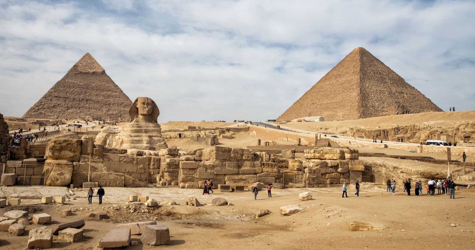 Panoramic view of the Pyramids of Giza with the Sphinx and desert landscape in Egypt