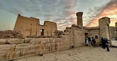 Front view of Edfu Temple with massive stone pylons and hieroglyphs along the Nile River